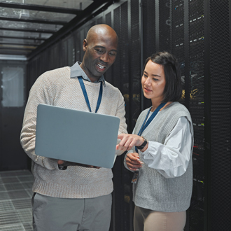 Two engineers working a server room