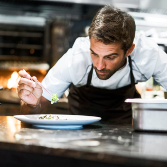 Chef garnishing a dish