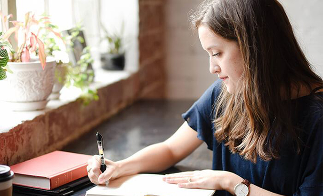 Student writing in a notebook