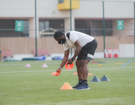 Male football coach setting up for practice