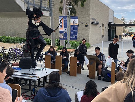 Students drawing model posing as a pirate