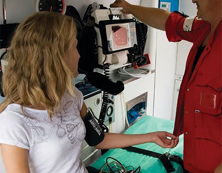 Male EMT takes young patient's blood pressure