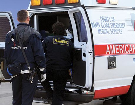 Two paramedics climb into back of ambulance