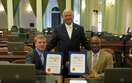 3 men holding awards