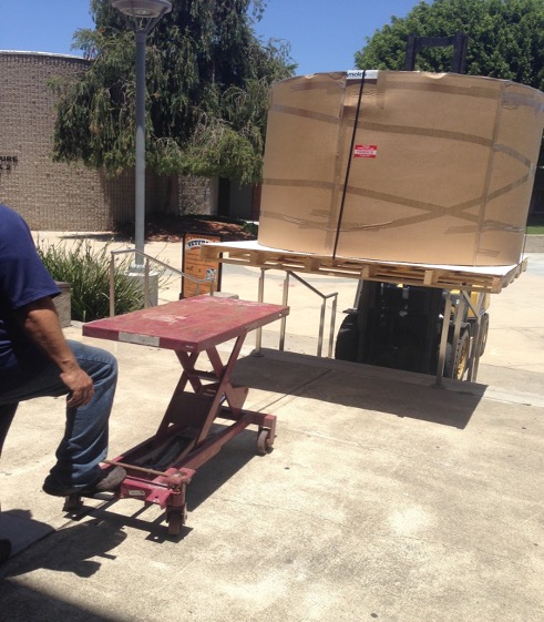 Moving round acrylic aquarium into Lewis Center lobby to replace hexagonal exhibit, 2015