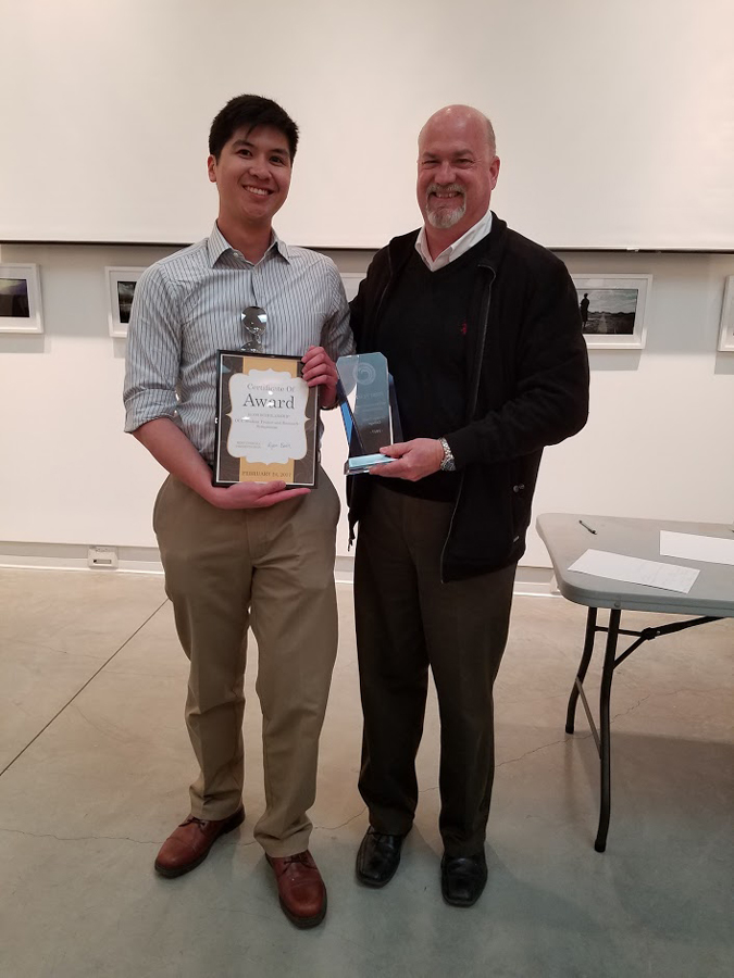 Ryan Bahn grand prize winner of the symposum with Dean Dr. Michael Sutliff