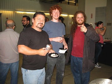 Group of people at the opening and having food.