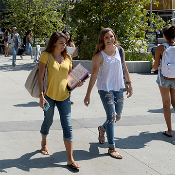 2 students walking by the MBCC building