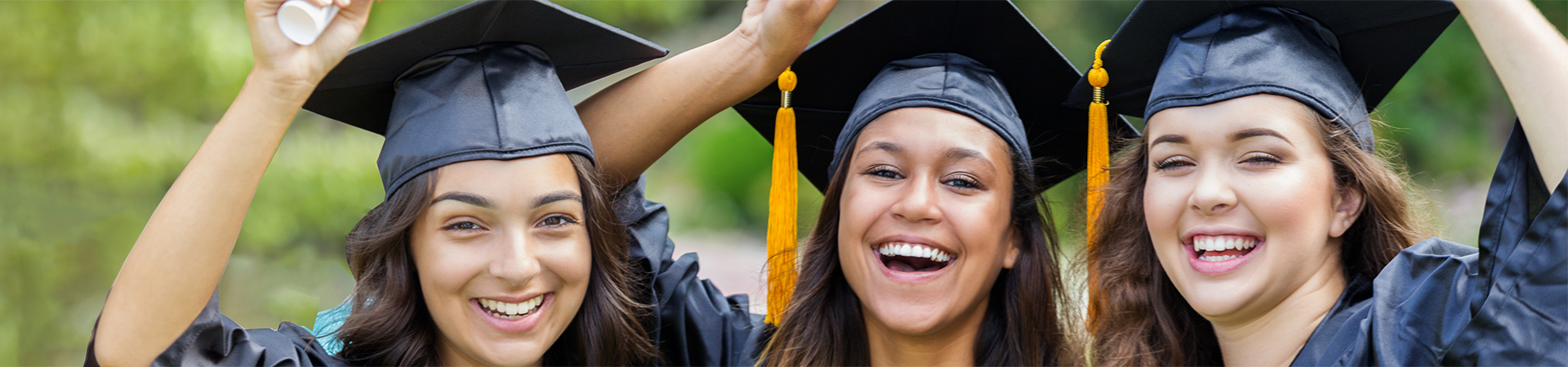 3 students celebrating at graduation