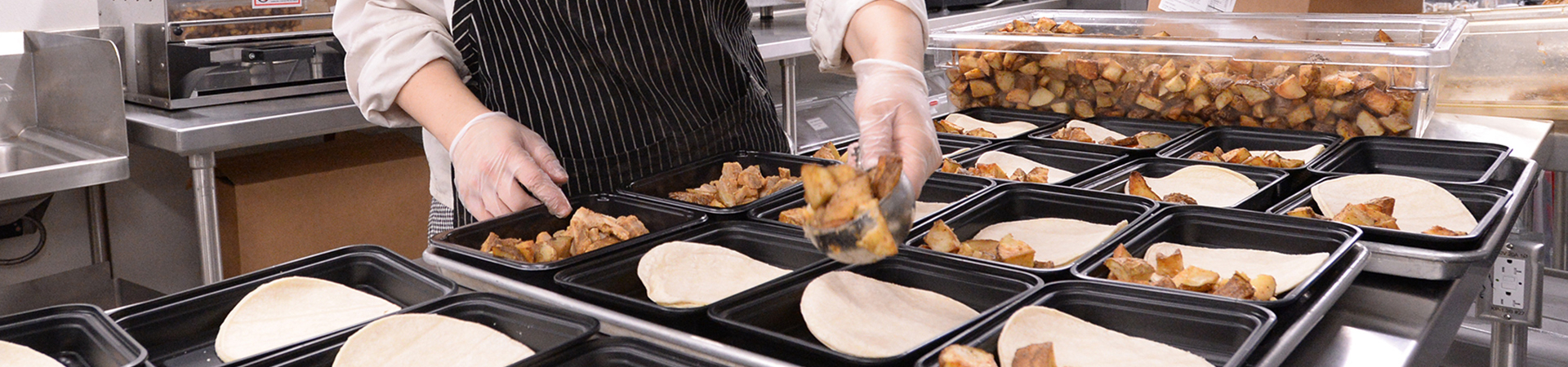 Chef distributing food to trays