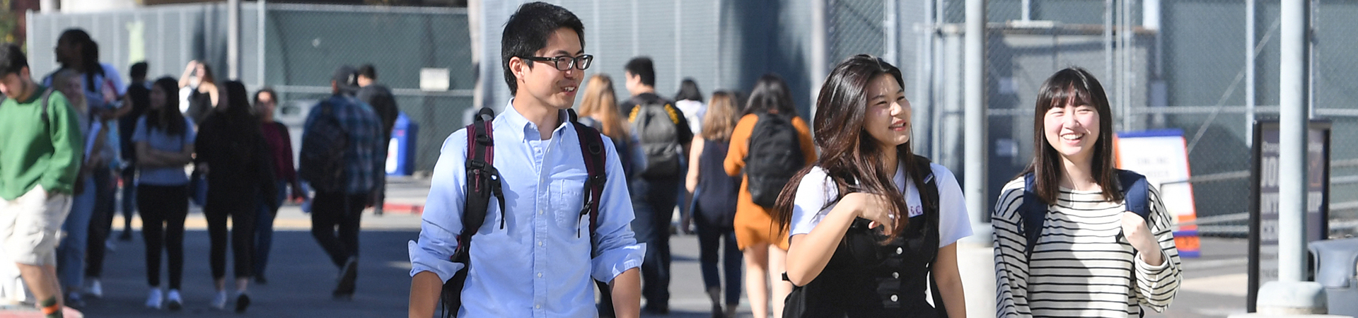 3 students walking together on campus