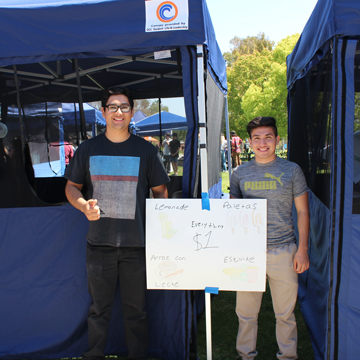 2 students selling food at an event