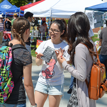 3 students talking at an event