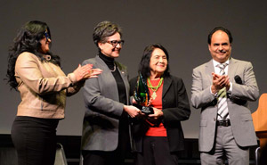 Dr. Angelica Suarez, Dolores Huerta, and Eric Cuellar on stage