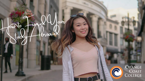 Young Asian woman standing on a Paris street with wind blowing her hair